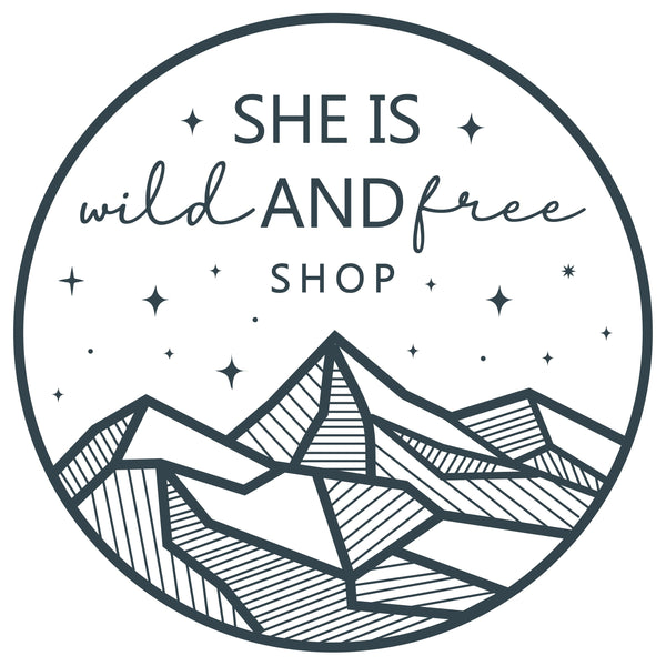 Logo of 'She is Wild and Free Shop' with mountains and text on a white background