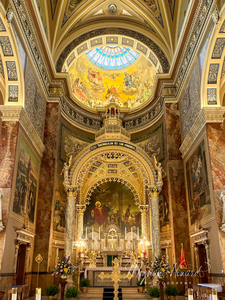 Interior of the Basilica of St. Josaphat in Milwaukee, showing the ornate altar, dome, and murals.