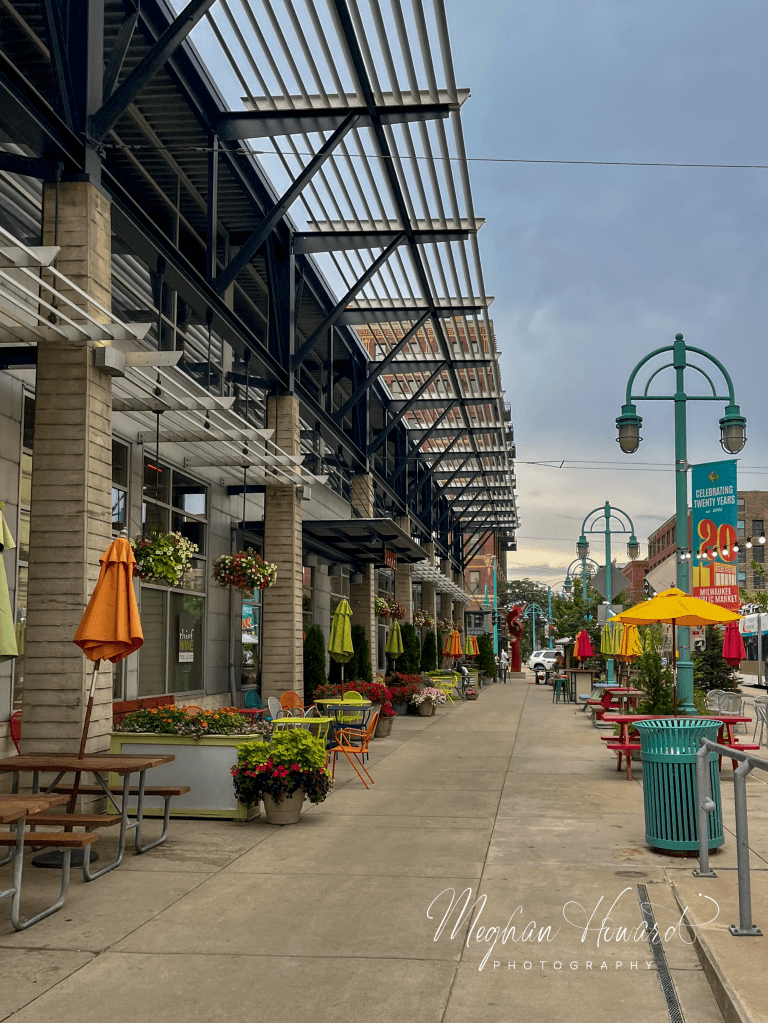 Outdoor seating with colorful umbrellas along a street in Milwaukee’s Historic Third Ward.