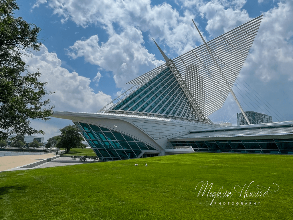 Exterior of the Milwaukee Art Museum with its iconic white winged structure against a blue sky.